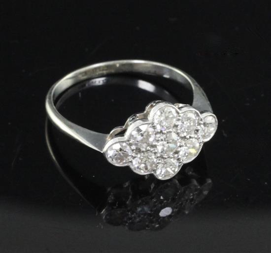 A mid 20th century 18ct white gold and nine stone diamond cluster lozenge shaped ring, size Q.